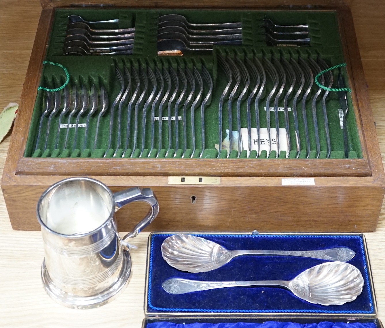 A Mappin & Webb canteen plated cutlery with ivorine inset, cased pair plated servers spoons and plated pint mug